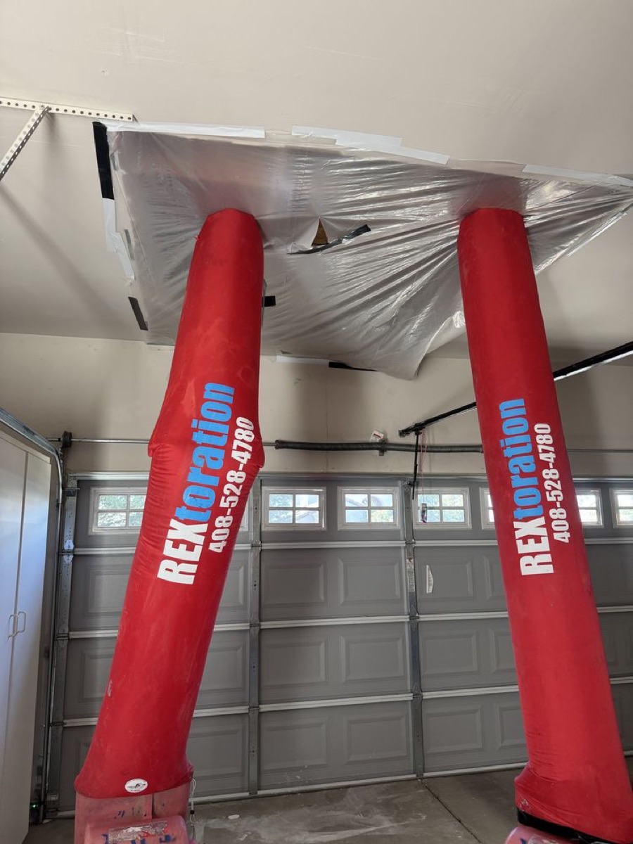 Rextoration branded structural drying tubes set up in a garage