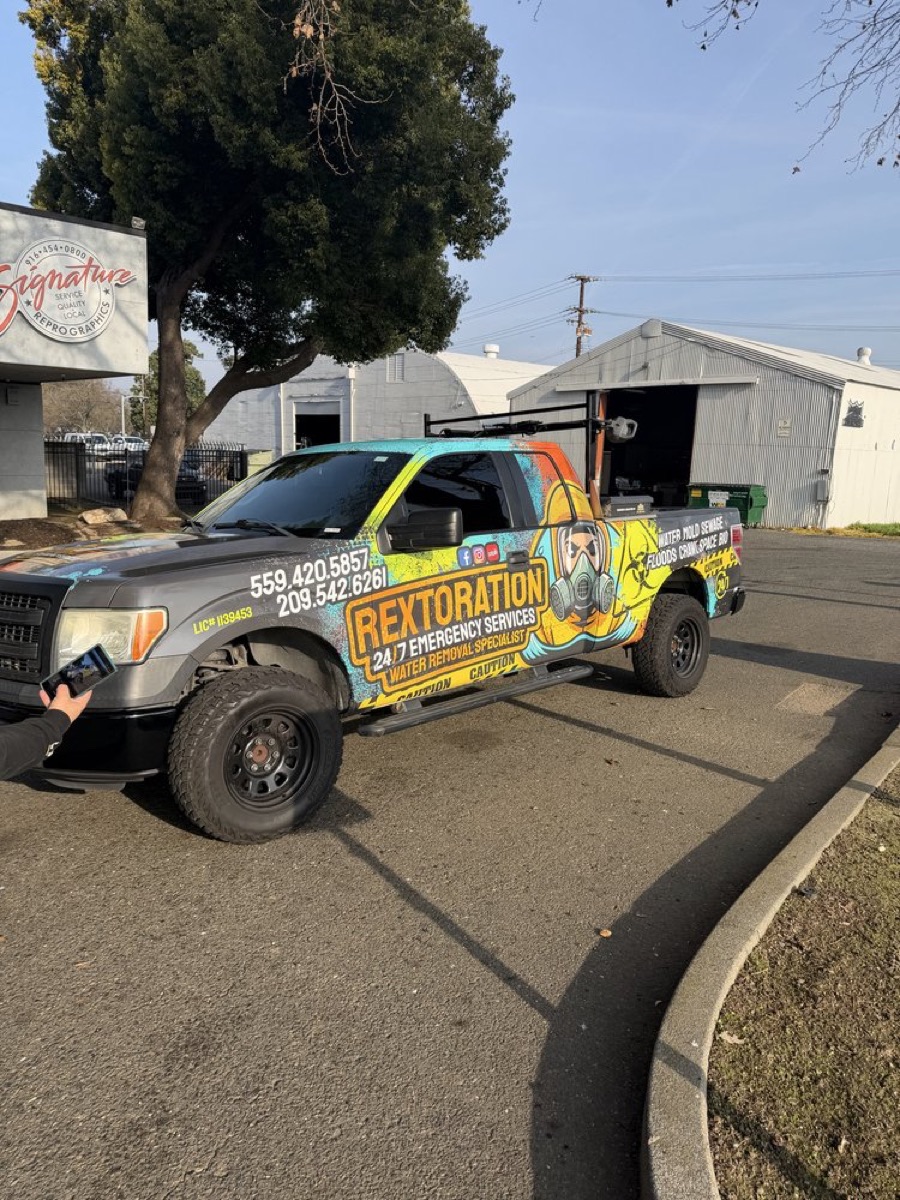 Rextoration branded pickup truck with company wrap and phone numbers